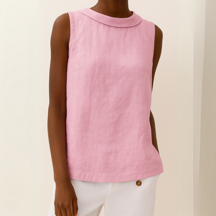 Model wearing a sleeveless, light pink linen-blend top with a modern roll collar and a relaxed, draped silhouette.