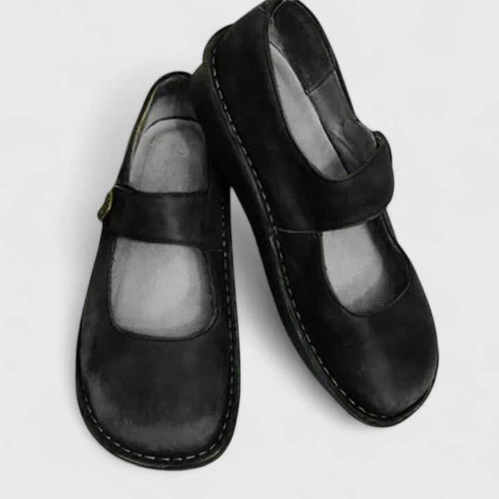 Black leather Talia orthopedic Mary Jane shoes with a rounded toe and adjustable strap.