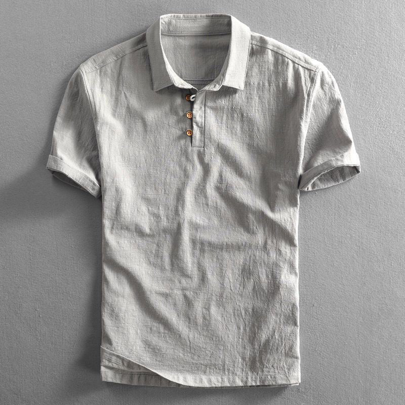 Men's light gray Troy short sleeve polo shirt with a classic collar, button placket, and textured fabric.