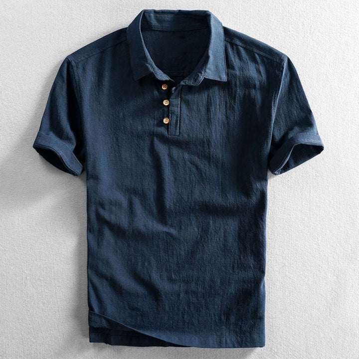 Men's Troy short sleeve polo shirt in navy blue with a classic collar and three wooden buttons.
