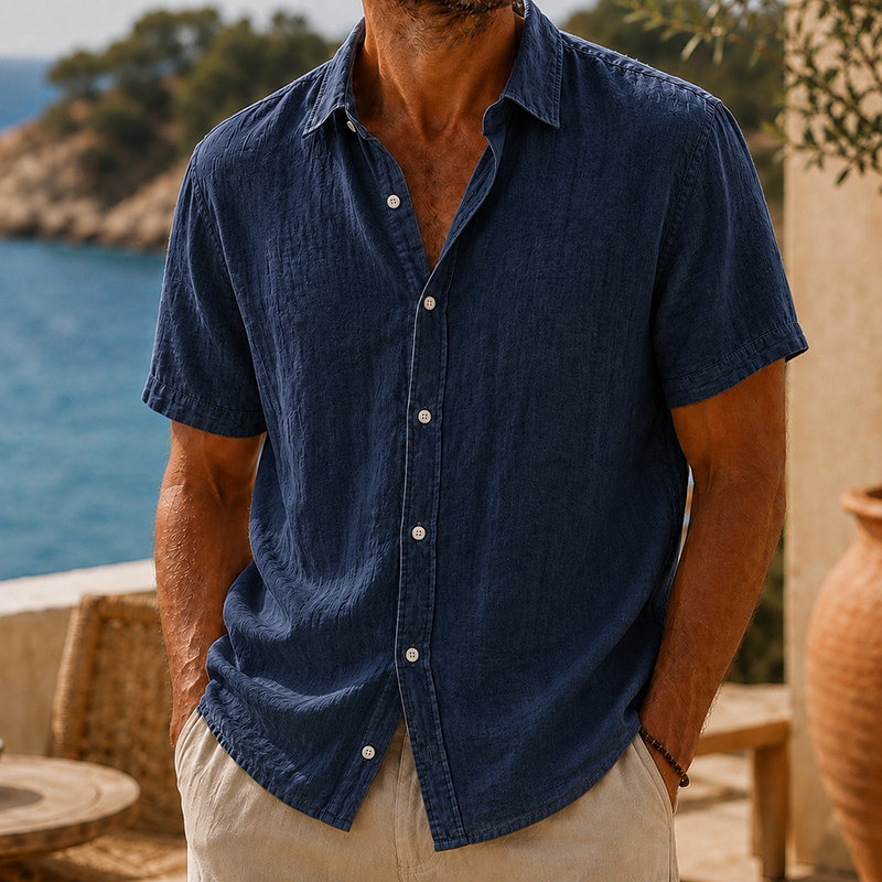 Men's navy linen short sleeve button shirt with a collared neckline, worn with khaki pants.