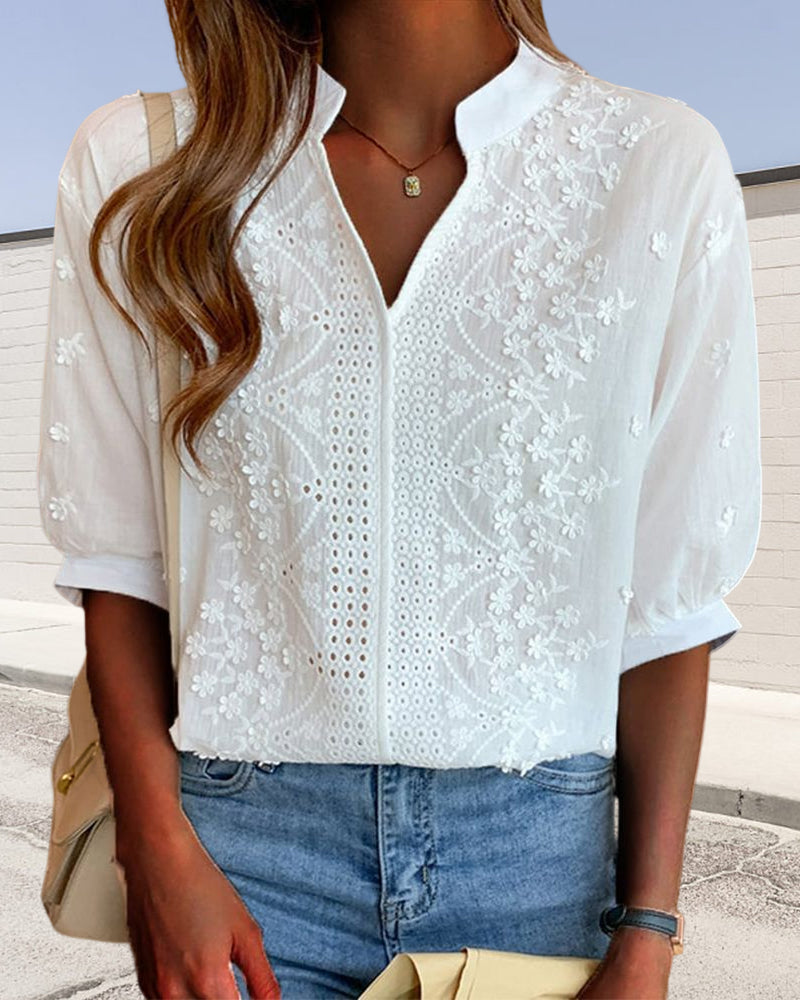 Women's Vera short sleeve white blouse with delicate floral embroidery, V-neck, and fluid drape.