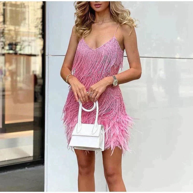 Pink sequin fringe mini dress with feather trim, spaghetti straps, and a V-neckline.